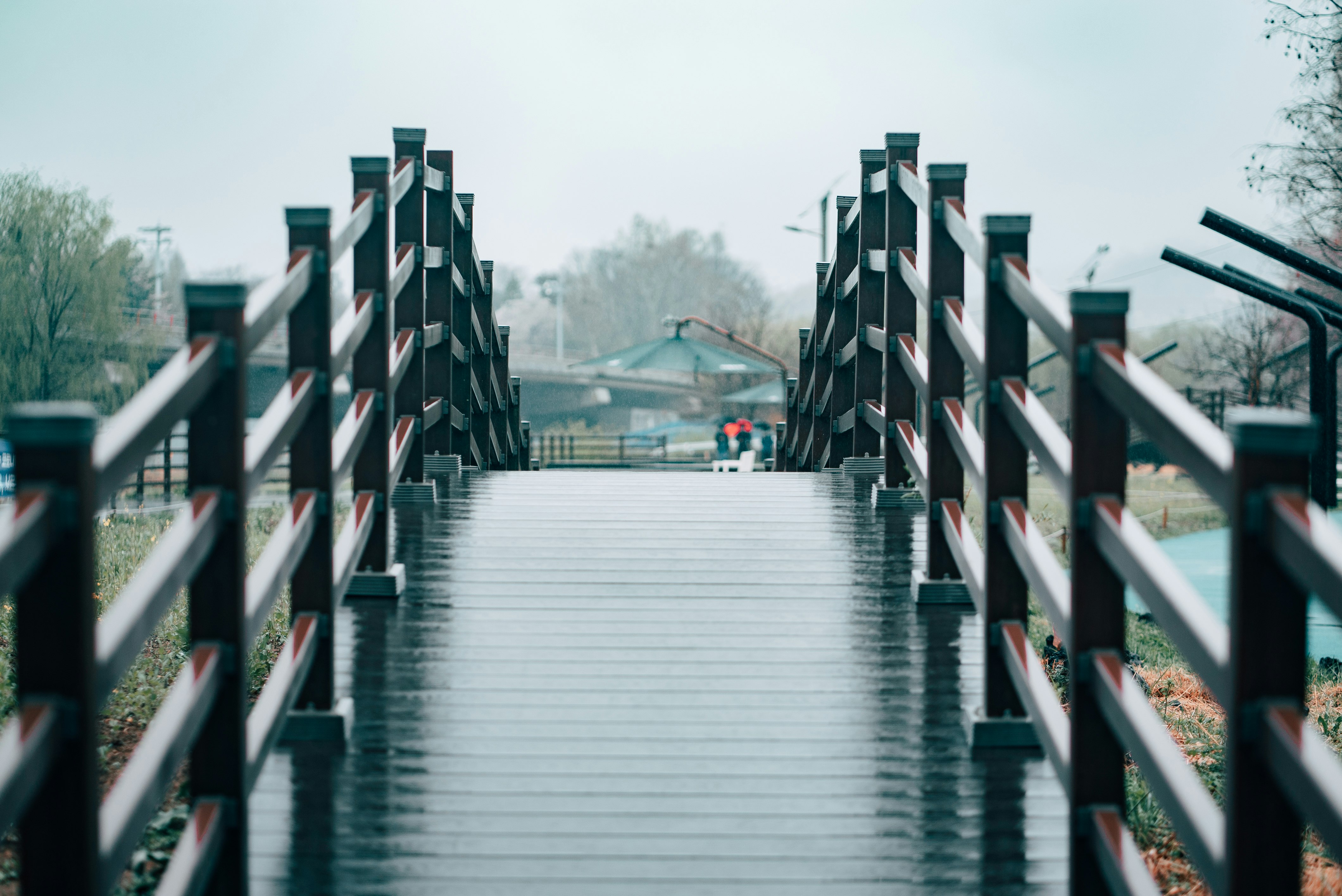 white and brown wooden bridge over river